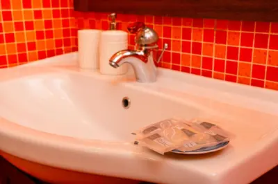 a white sink with a faucet and toilet paper on it at Casa Relax Mondello in Mondello