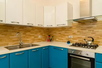 a kitchen with blue cabinets and a sink at Casa Relax Mondello in Mondello