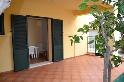 an open door to a patio with a table at La Casa Gialla in Trabia