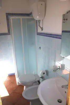 a bathroom with a toilet and a sink at La Casa Gialla in Trabia