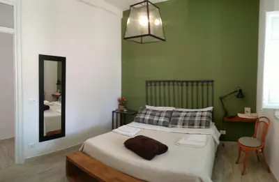 a bedroom with a bed with a floral bedspread at La terrazza del Sole B&B in Palermo