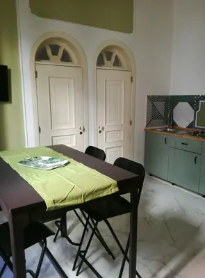 a black lamp sitting on a table with a remote control at La terrazza del Sole B&B in Palermo