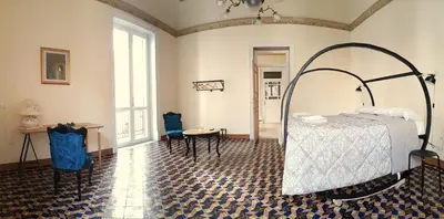 a bedroom with a bed and a table and chairs at Artisan Maison Palermo in Palermo