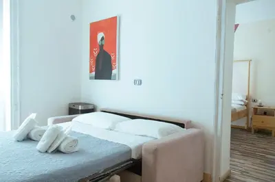 a bedroom with a bed and a painting on the wall at Artisan Maison Palermo in Palermo