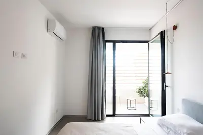 a bedroom with a bed and a large window at Alkamuri Posh Hotel e Spa in Alcamo