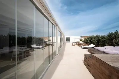 an external view of a building with glass walls at Alkamuri Posh Hotel e Spa in Alcamo