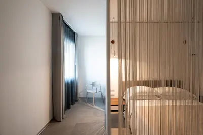 a bedroom with a bed and a glass door at Alkamuri Posh Hotel e Spa in Alcamo