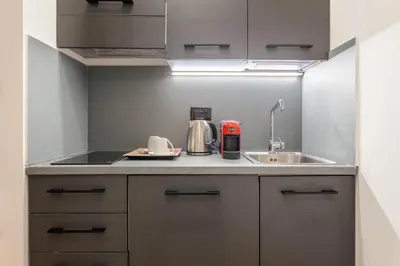 a kitchen with a sink and a counter with a appliance at Quinto Stabile Rooms&Suite in Palermo