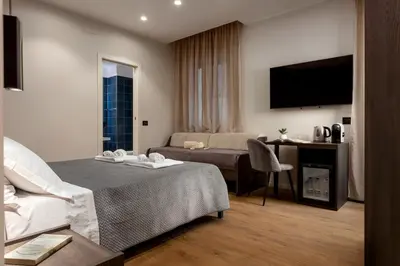 a hotel room with a bed and a couch at Quinto Stabile Rooms&Suite in Palermo