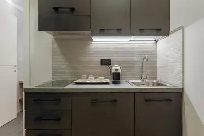 a kitchen with a sink and a counter top at Quinto Stabile Rooms&Suite in Palermo
