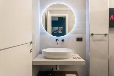 a bathroom with a sink and a mirror at Quinto Stabile Rooms&Suite in Palermo