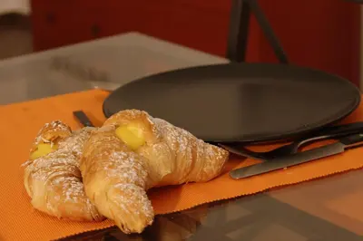 a pair of croissants sitting next to a pan at palermo casa vacanze in Palermo