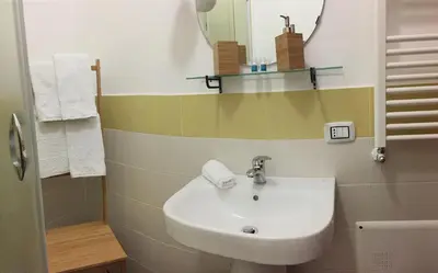 a bathroom with a sink and a mirror at palermo casa vacanze in Palermo