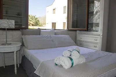 a bedroom with two beds with towels on it at Villa Degli Ulivi Flora in Mondello
