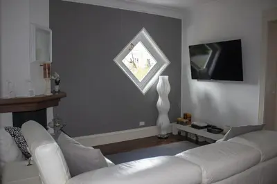 a living room with a white couch and a window at Villa Degli Ulivi Flora in Mondello