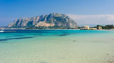 a view of the beach with a mountain in the background at Villa Degli Ulivi Flora in Mondello