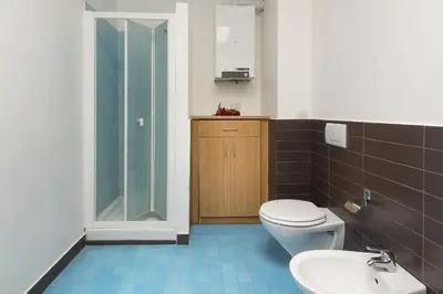 a bathroom with a toilet and a sink and a shower at Calarossa Seaview by Wonderful Italy in Terrasini