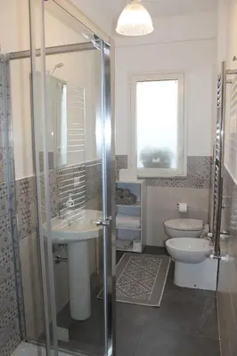 a bathroom with a shower and a sink and a toilet at Casa Vacanza Peppino! in Palermo