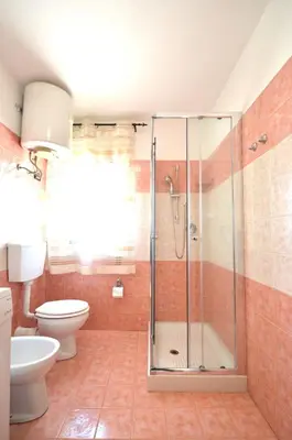 a bathroom with a shower and a toilet at Villa Bianca e Villa Arancio in Alcamo