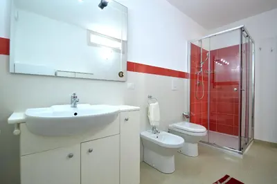 a bathroom with a sink and a toilet at Villa Bianca e Villa Arancio in Alcamo