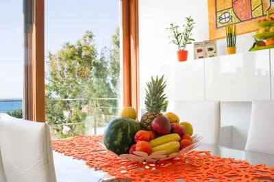 a bowl of fruit on a table in front of a window at Villa Perla del Mare in Alcamo Marina