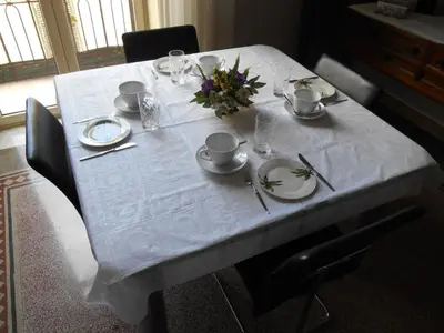 a table with a white table cloth on top of it at 4You in Palermo