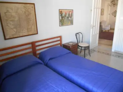 a bed with blue sheets in a bedroom at 4You in Palermo