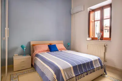 a bedroom with a bed and a window at La Casa di Sara a Mondello by Wonderful Italy in Mondello