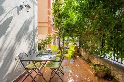 a patio with a table and chairs on a balcony at La Casa di Sara a Mondello by Wonderful Italy in Mondello