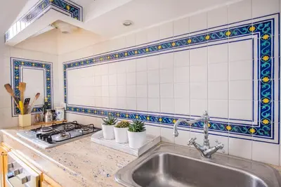 a kitchen with a sink and a stove at La Casa di Sara a Mondello by Wonderful Italy in Mondello