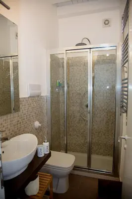 a bathroom with a shower and a sink and a toilet at Vista Capo in Palermo