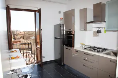 a kitchen with a sink and a stove top oven at Vista Capo in Palermo