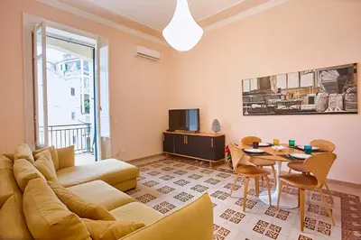 a living room with a couch and a table at KMC suites - Yellow in Palermo