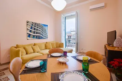 a living room with a couch and a table at KMC suites - Yellow in Palermo