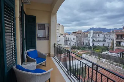 a balcony with chairs and a view of a city at KMC suites - Yellow in Palermo