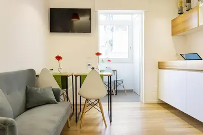 a living room with a couch and a table at Kalamonjo Suite&Rooms in Palermo