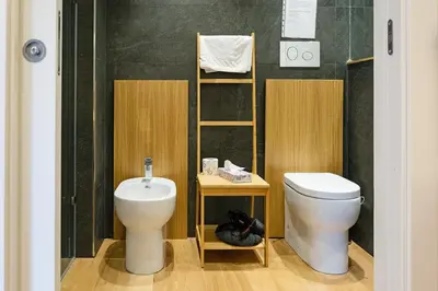 a bathroom with a toilet and a sink at Kalamonjo Suite&Rooms in Palermo