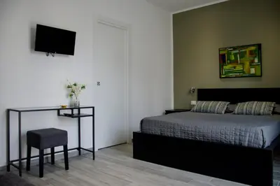 a bedroom with a bed and a table and a television at Cavour37 Rooms in Palermo