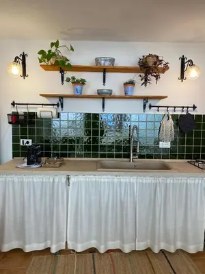 a kitchen sink with a white table cloth on it at La depandance di Villa Rosa locazioni brevi in Mondello