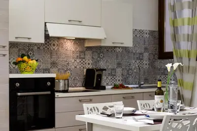 a kitchen with a table with a bottle of wine at Casa Francesco in San Vito lo Capo