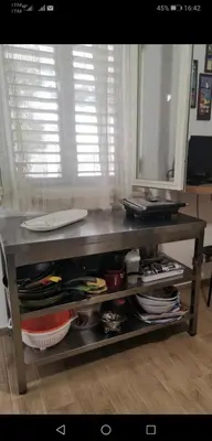 a table with a shelf with plates and dishes at Villetta Delizia in Scopello