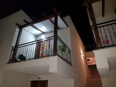 a staircase in a building with a balcony at Appartamento Le Ginestre in San Vito lo Capo