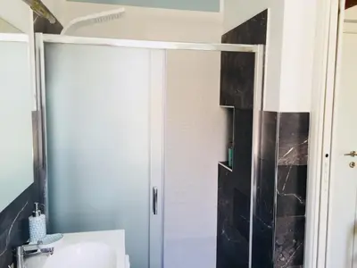 a bathroom with a shower and a sink at Gò Gò House in Palermo