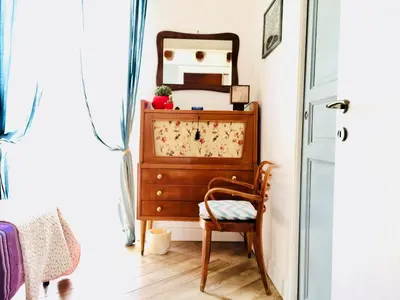 a room with a dresser and a chair and a mirror at Gò Gò House in Palermo