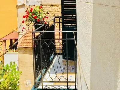 a fire escape on the side of a building with flowers on it at Gò Gò House in Palermo