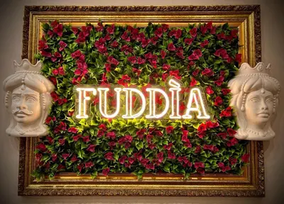 a sign that says fudida with red flowers at FUDDIA Room & Suite in Palermo