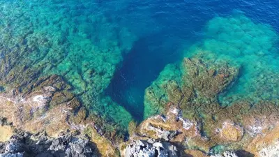 an aerial view of the ocean and reefs at Villa Majus in Porticello
