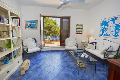 a living room with a couch and chairs and a table at Villa Majus in Porticello