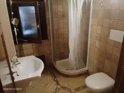 a bathroom with a white sink and a mirror at Villa Amalia - mansarda B&B in Cinisi