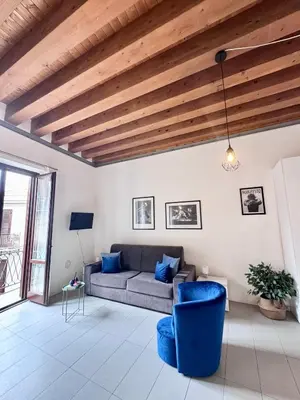 a living room with a couch and a wooden ceiling at Capo Loft in Palermo